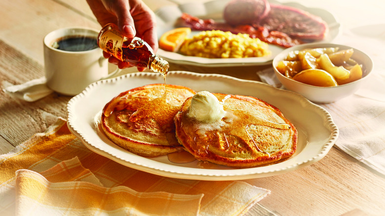 Syrup being poured over Grandma's Sampler breakfast platter at Cracker Barrel
