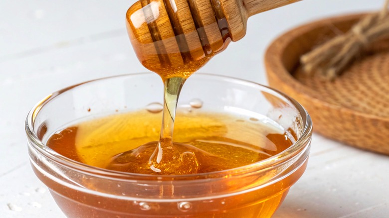 Bowl of honey with honey dipper