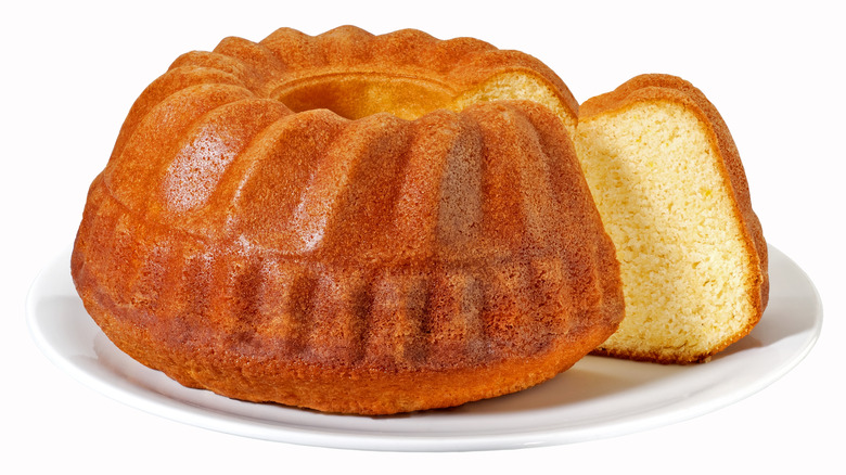 Bundt cake on white plate with slice taken out