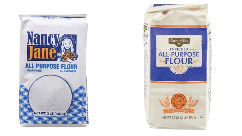 A bag of Nancy Jane all-purpose flour and a bag of Clover Valley all-purpose flour on a white background