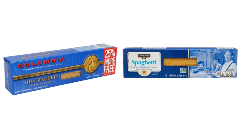 A 20-ounce box of Columbia thin spaghetti and a 16-ounce box of Clover Valley spaghetti on a white background