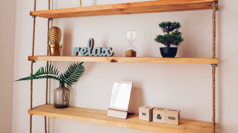 Hanging shelves against a wall with trinkets on them