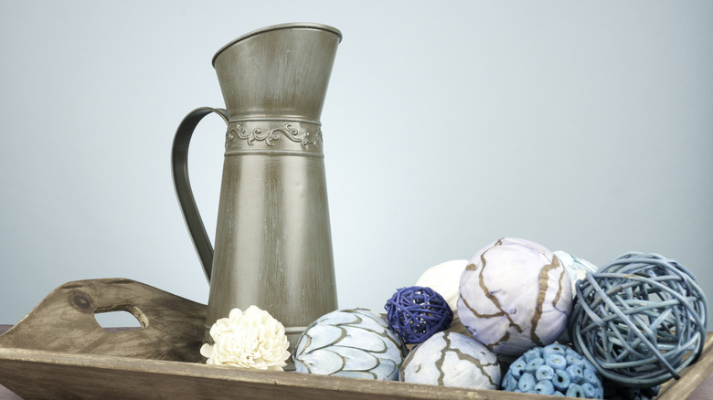 Decorative pitcher on a tray