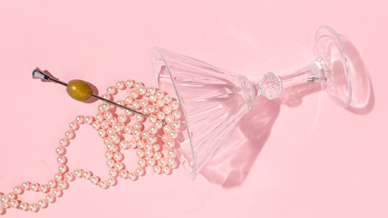 martini glass with pearls and an olive