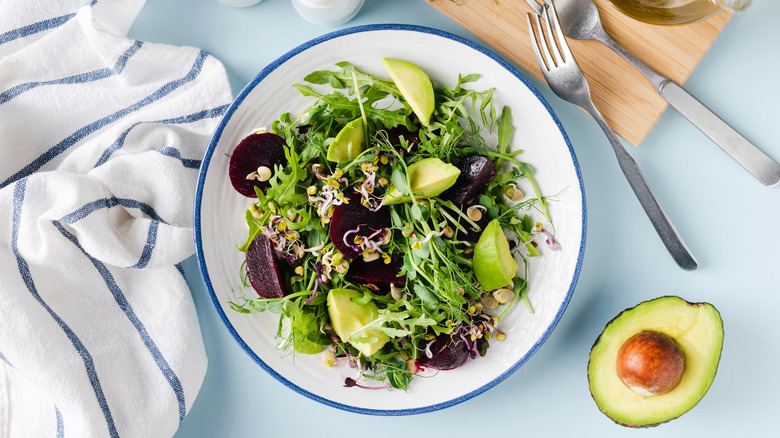 An avocado, beetroot and arugula salad.