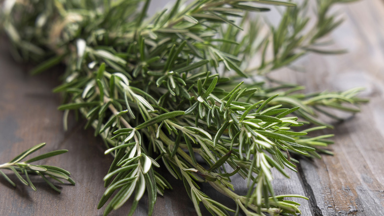 A bunch of herbs on a wooden table
