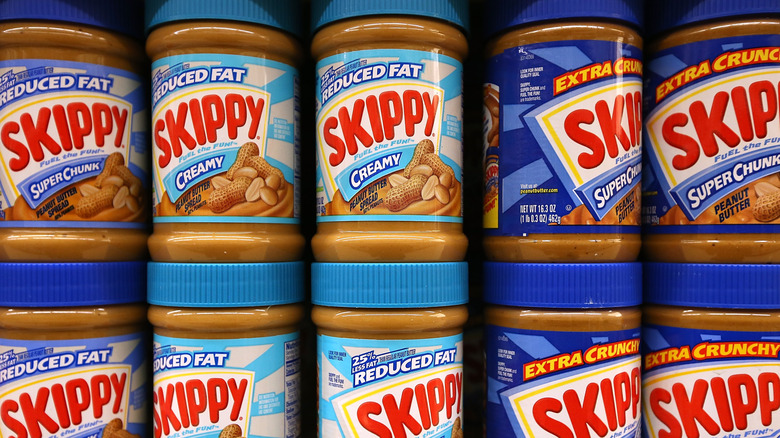 Rows of Skippy peanut butter jars on store shelf
