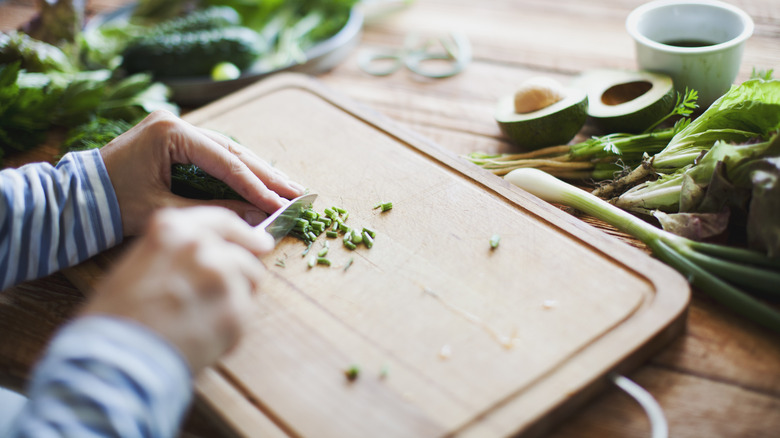Person chopping vegetables on a cutting board