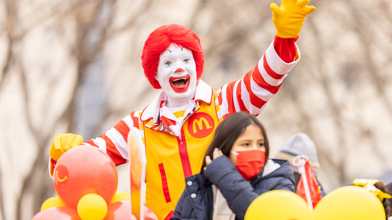 Ronald McDonald surrounded by some balloons