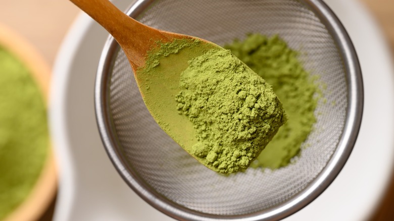 Sifting matcha powder through a fine sieve