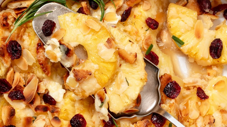 Close-up of a spoon digging into a pineapple casserole