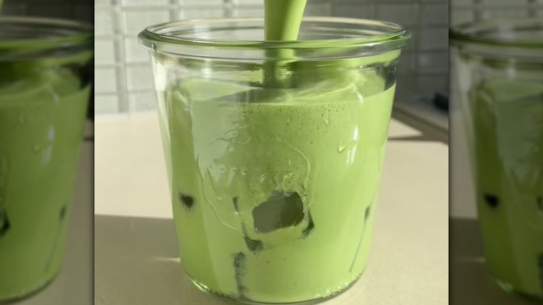 Pouring a matcha latte into a Weck canning jar