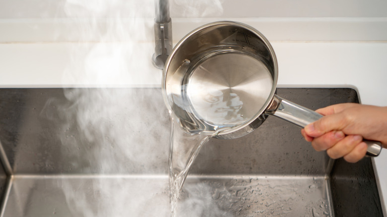 Boiling water being poured into the sink