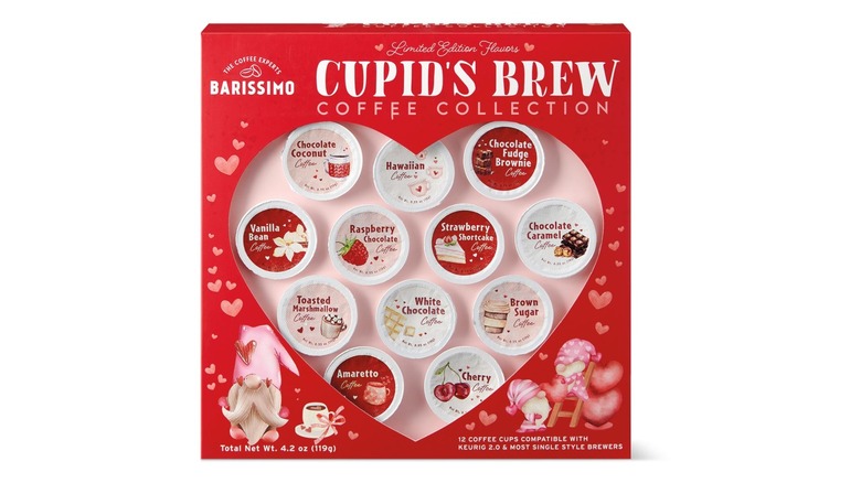 A square box with a clear heart-shaped panel revealing an assortment of flavored coffee cups