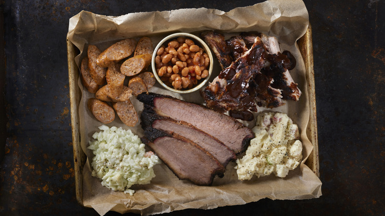 Tray of barbecue meat with sides.
