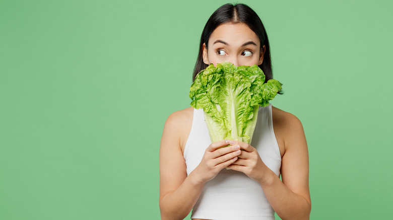 person holding lettuce