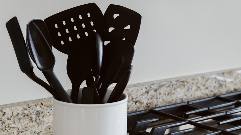 Jar of black cooking utensils