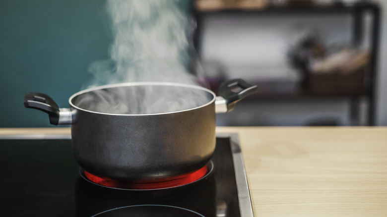 A boiling pot with steam rising from it