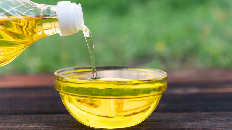 Pouring canola oil into bowl