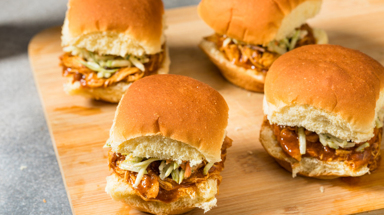 BBQ chicken sliders with coleslaw on a cutting board