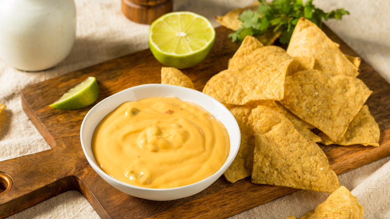 nacho cheese in a  bowl with tortilla chips