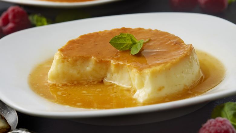 Half-eaten flan on white plate