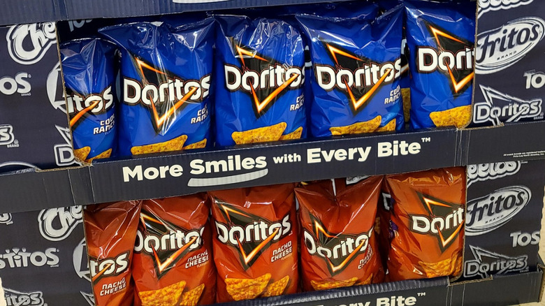In-store Doritos display with Golden Sriracha, Cool Ranch, and Nacho Cheese varieties.
