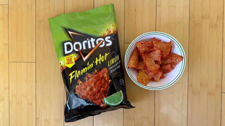 Bag of Flamin' Hot Limón Doritos beside filled bowl of chips