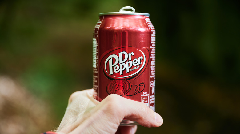 Hand holding Dr Pepper