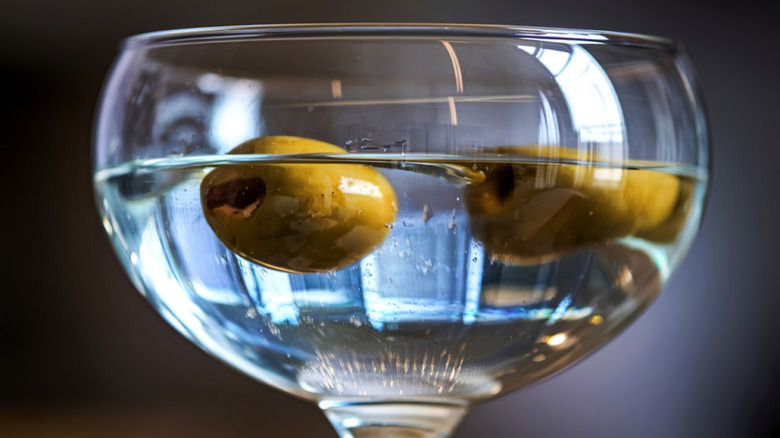 A martini with olives in close-up.