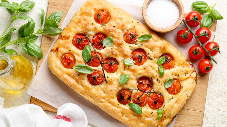 Tomato and basil focaccia on a cutting board
