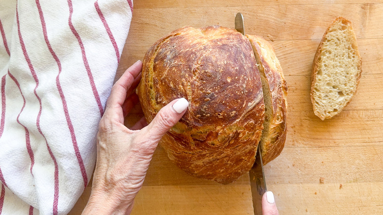 hands slicing bread