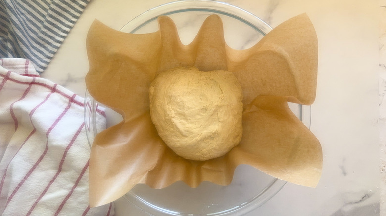 dough on parchment in bowl