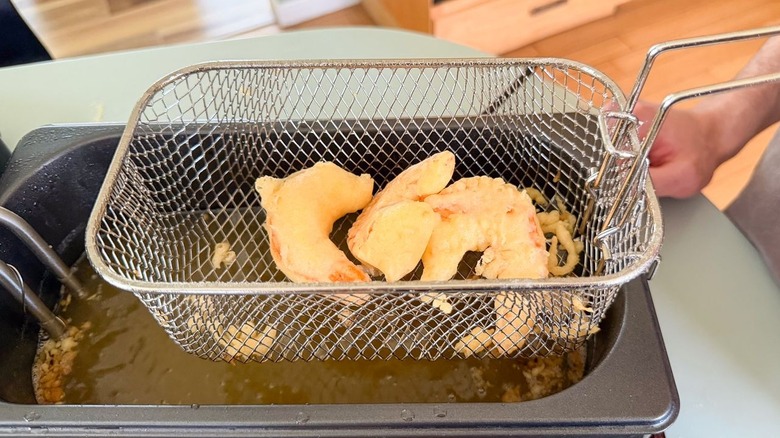Fried battered shrimp in fryer basket