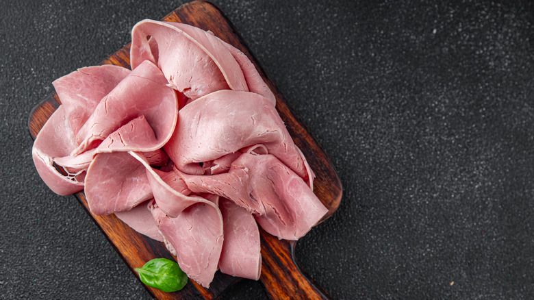 Sliced ham on wooden board