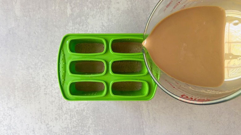 Pouring Vietnamese coffee into popsicle molds