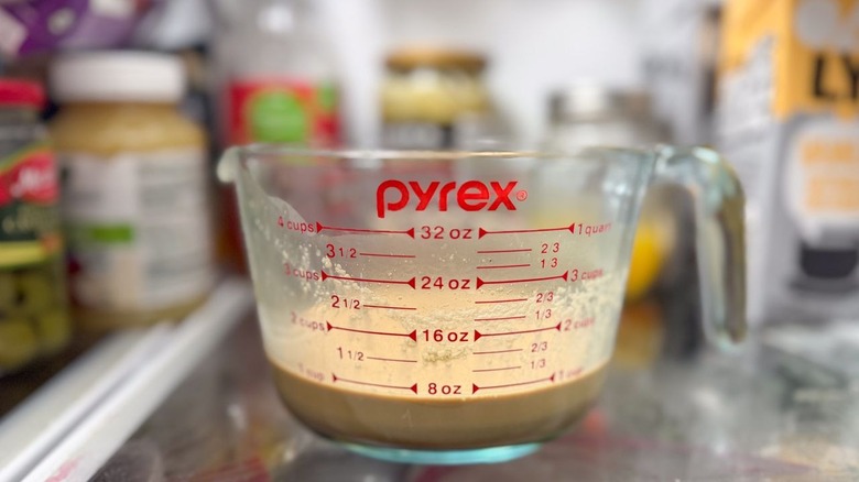 Vietnamese coffee popsicle base in glass measuring cup in refrigerator