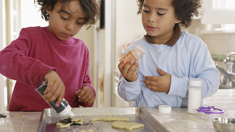 Two children decorating homemade cookies