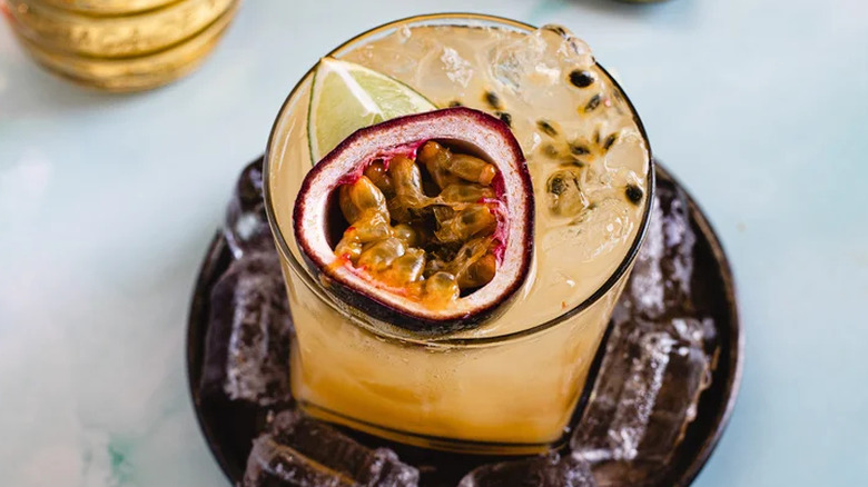 Passion Fruit Caipirinha topped with lime wedge and passionfruit garnish