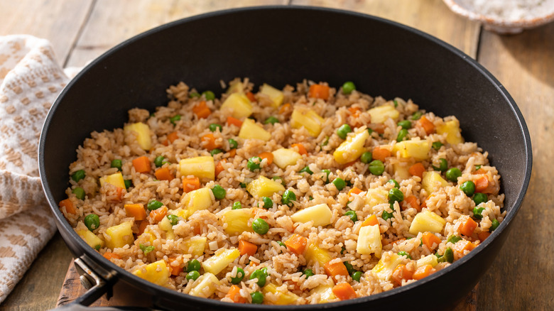 Hawaiian fried rice with pineapples in a pan served on a table