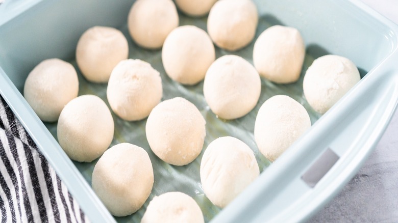 frozen dinner rolls in a baking pan.