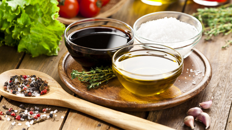 oil, vinegar, and seasonings on a wooden table