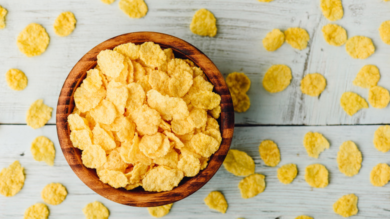 Cornflakes in a rustic wooden bowl.