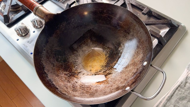 Peanut and sesame oils in wok on stovetop