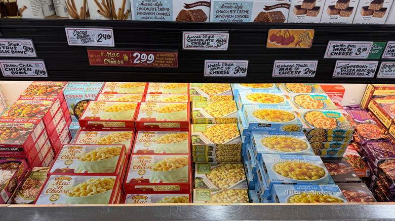 Different versions of Trader Joe's frozen mac and cheese on the freezer aisle
