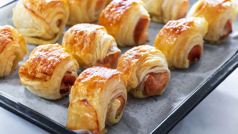 Puff pastry sausage appetizers on a sheet pan