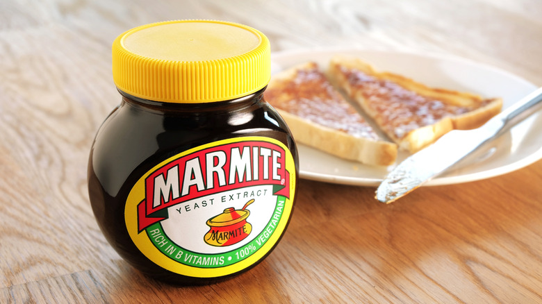 jar of marmite next to a plate of toaste