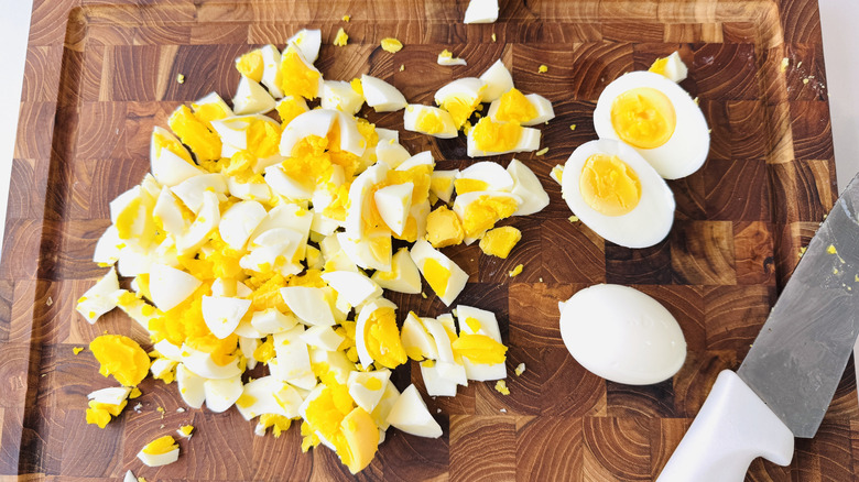 Chopping hard boiled eggs on cutting board