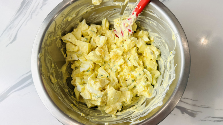 Mixing egg salad in bowl
