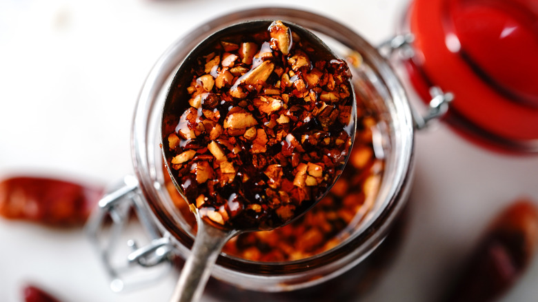 Close-up of homemade chili crisp on a metal spoon